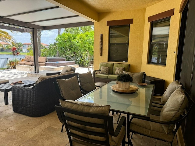 view of patio with outdoor lounge area and a water view