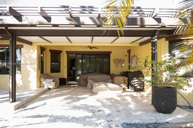 entrance to property featuring a pergola, a patio, and ceiling fan