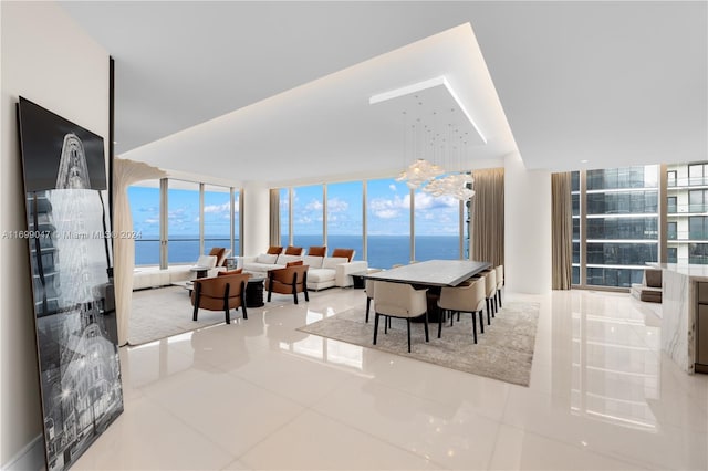 tiled dining area featuring floor to ceiling windows and a water view