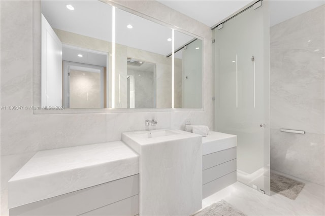 bathroom with vanity and tile walls