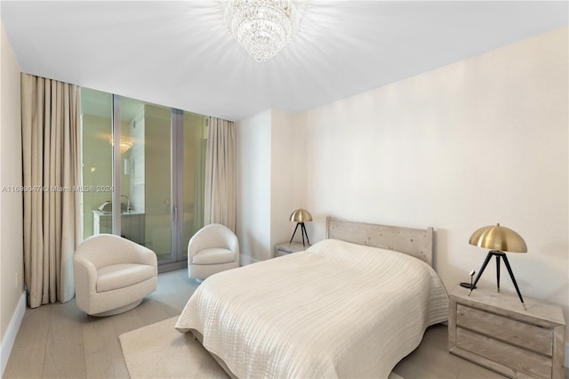 bedroom featuring light hardwood / wood-style floors and an inviting chandelier