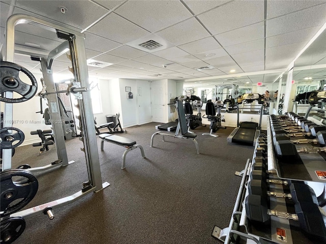 gym with a paneled ceiling