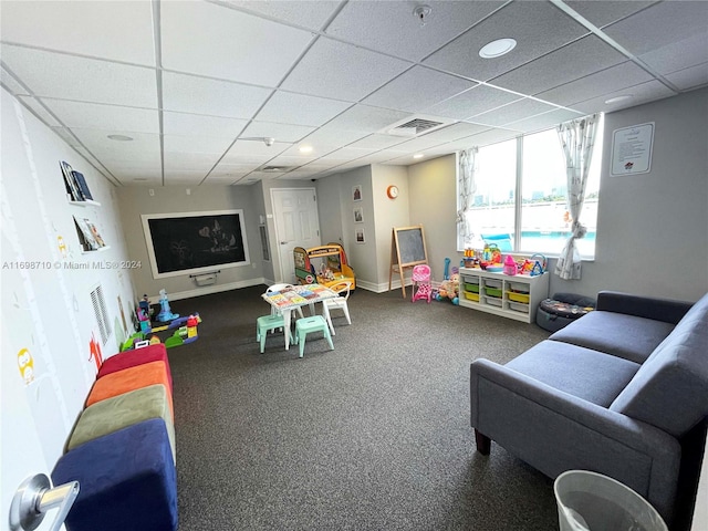 recreation room featuring a paneled ceiling and carpet