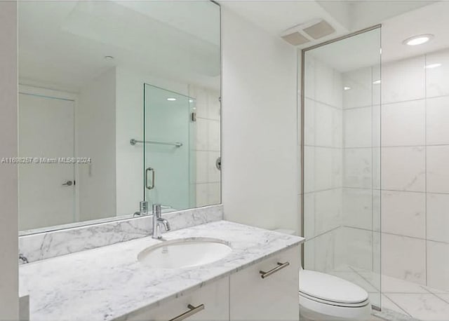 500 Brickell Ave Unit 2910, Miami, FL 33131 - bathroom featuring vanity, toilet, and a shower with shower door