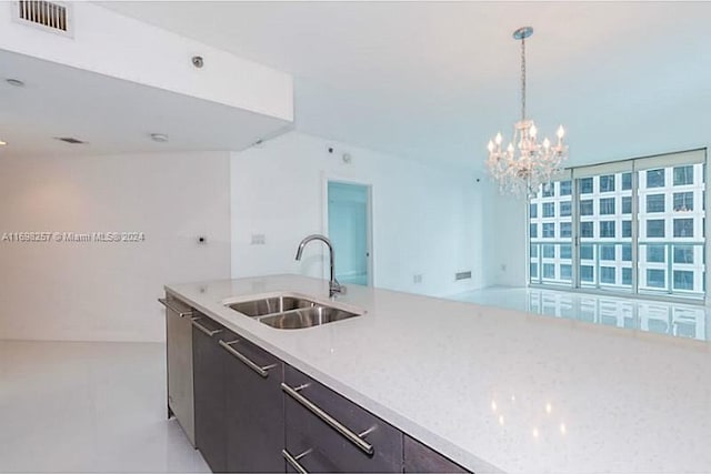 500 Brickell Ave Unit 2910, Miami, FL 33131 - kitchen with an inviting chandelier, sink, hanging light fixtures, light stone counters, and dark brown cabinetry