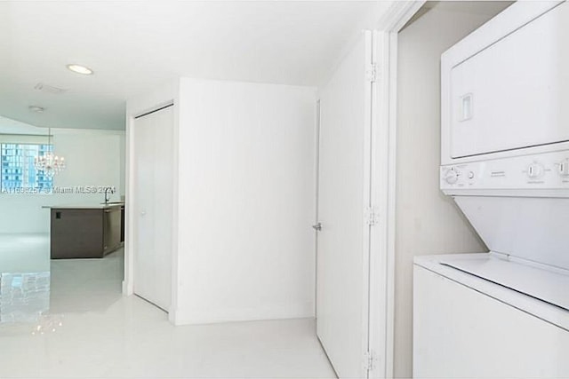 500 Brickell Ave Unit 2910, Miami, FL 33131 - washroom featuring stacked washer and dryer, a notable chandelier, and sink