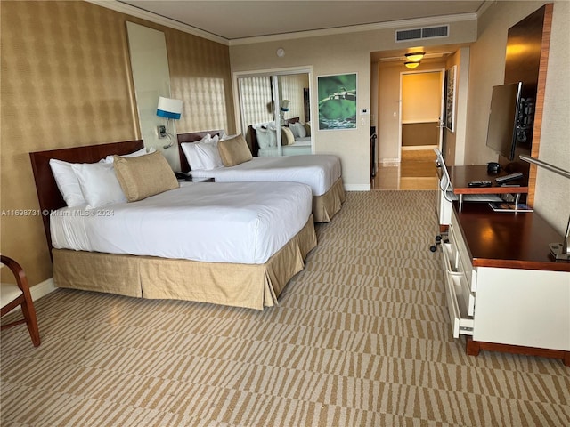 bedroom featuring light colored carpet and ornamental molding