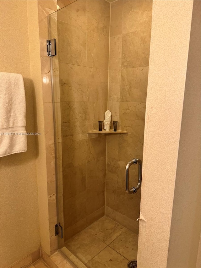 bathroom with a shower with door