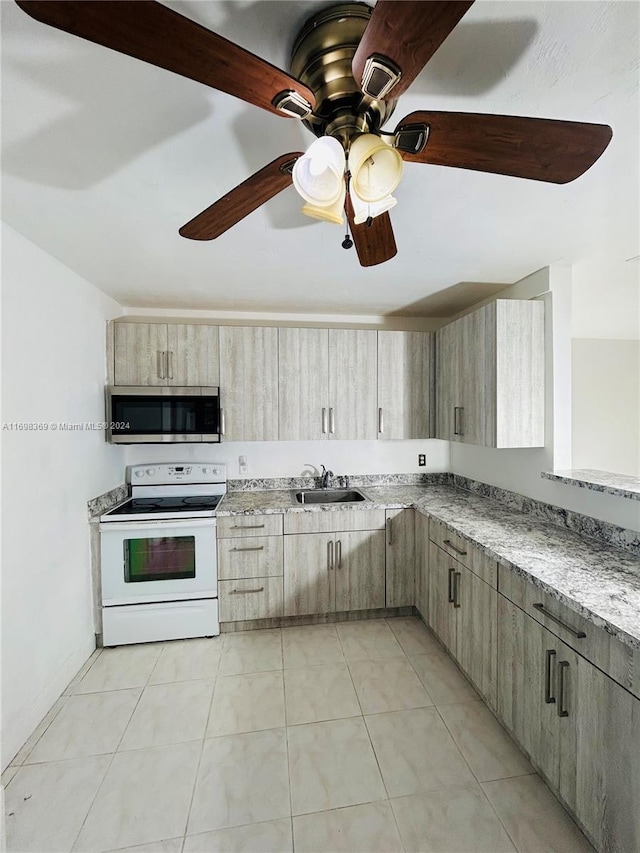 kitchen featuring light stone counters, ceiling fan, sink, light tile patterned floors, and white range with electric cooktop