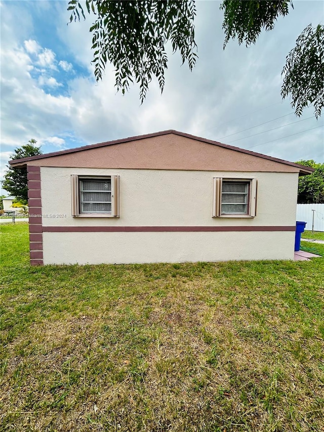 view of side of home featuring a yard