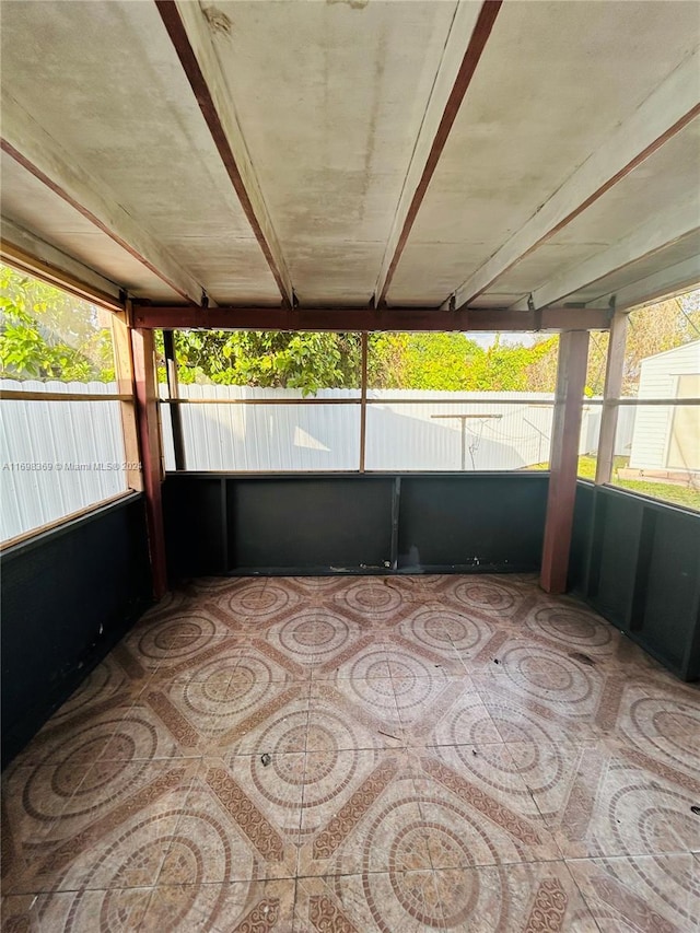 unfurnished sunroom featuring plenty of natural light