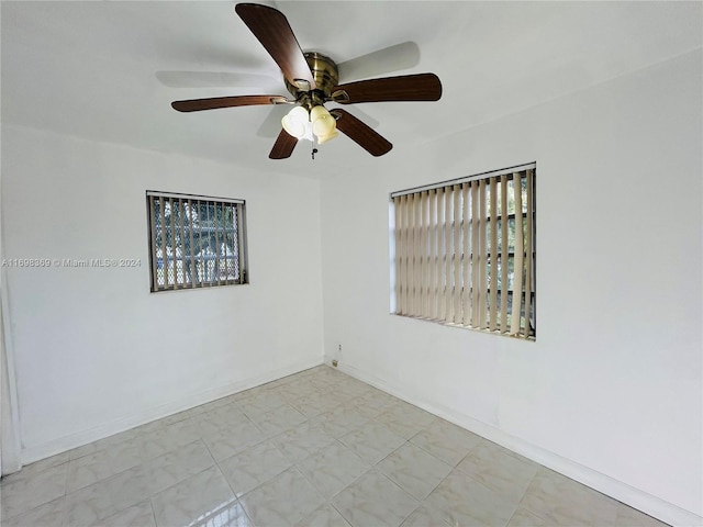 spare room with a wealth of natural light and ceiling fan