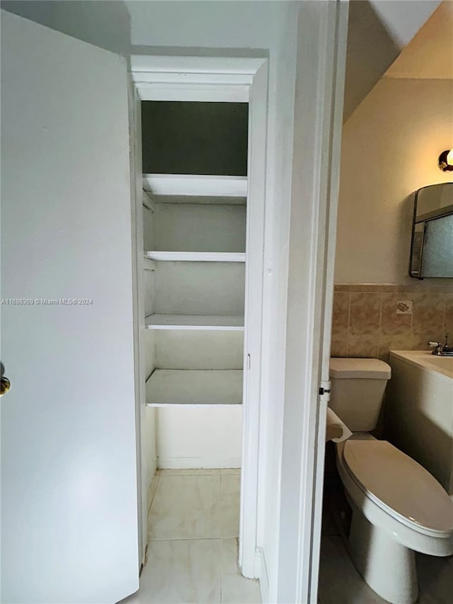 bathroom with tile patterned floors and toilet