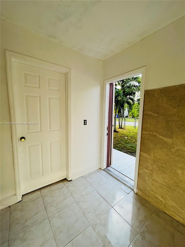 doorway with light tile patterned floors