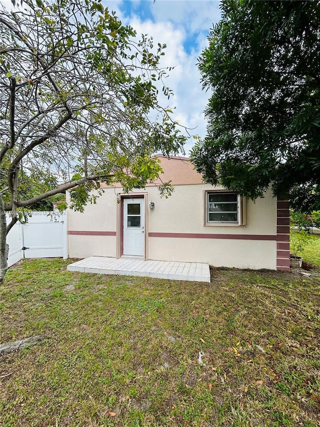 rear view of property featuring a yard