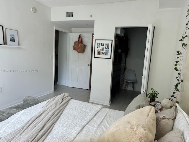 bedroom featuring wood-type flooring and a closet