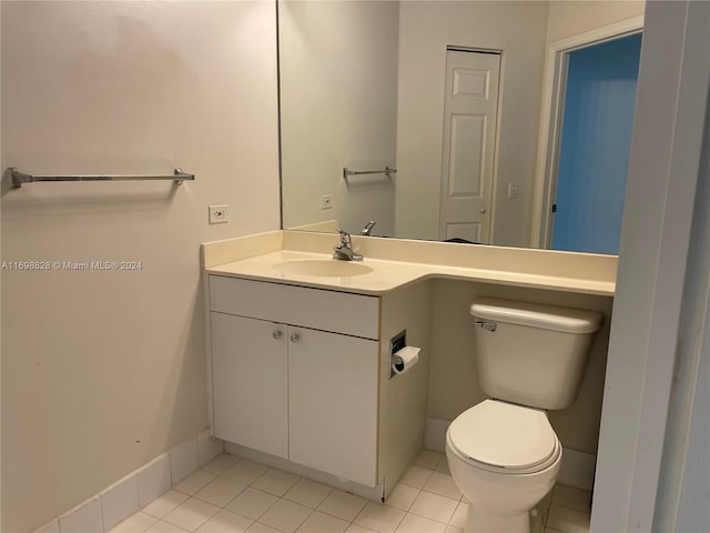 bathroom with tile patterned floors, vanity, and toilet