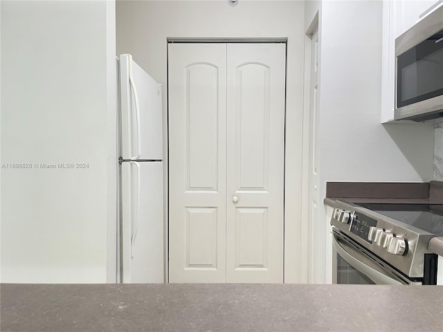 kitchen with white cabinetry and stainless steel appliances