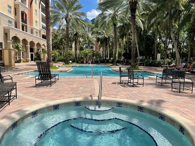 view of pool featuring a patio area and a hot tub