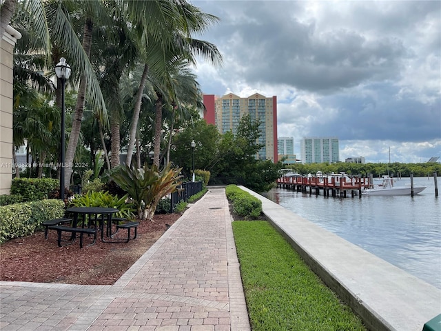 view of community featuring a water view and a boat dock