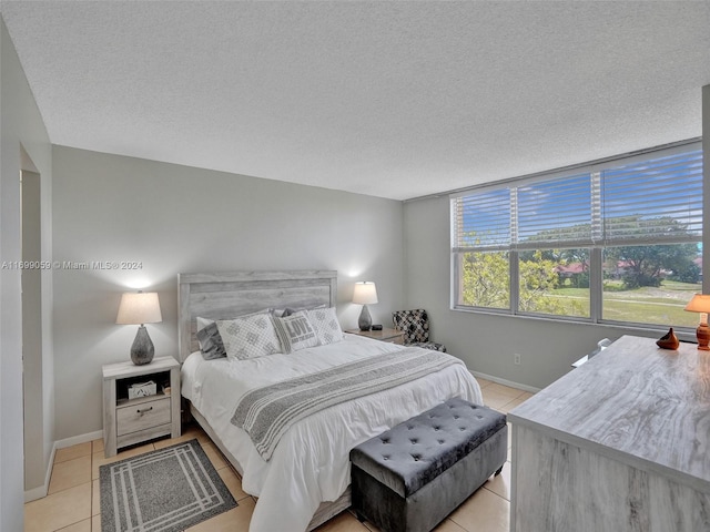 tiled bedroom featuring a textured ceiling