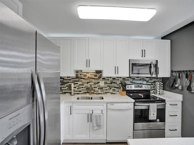 kitchen with white cabinets, stainless steel appliances, and sink