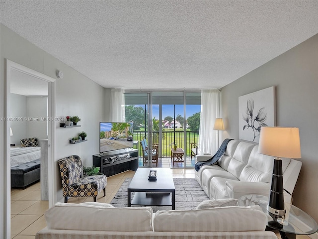 tiled living room with a textured ceiling and expansive windows