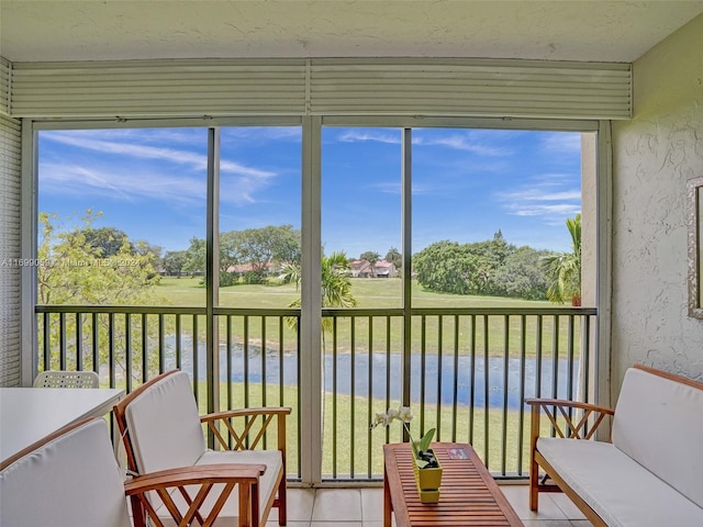 sunroom with plenty of natural light and a water view