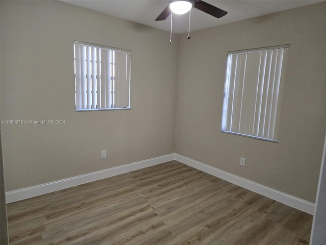 spare room with ceiling fan and wood-type flooring