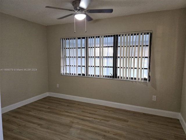 spare room featuring ceiling fan and dark hardwood / wood-style flooring