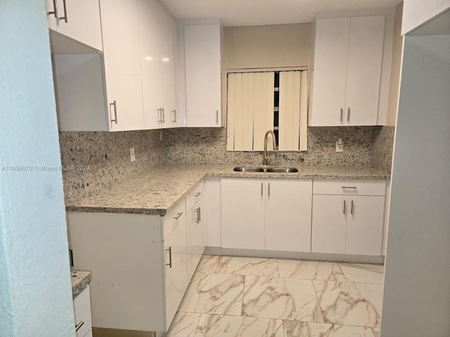 kitchen with white cabinetry and sink