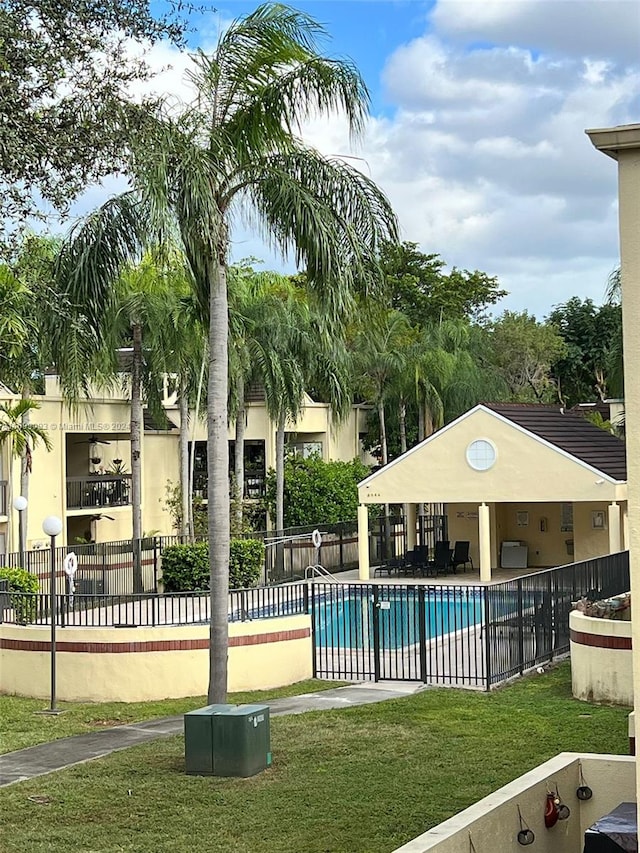 view of swimming pool with a lawn and a patio