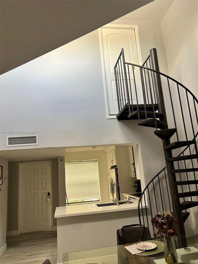 stairs featuring hardwood / wood-style flooring