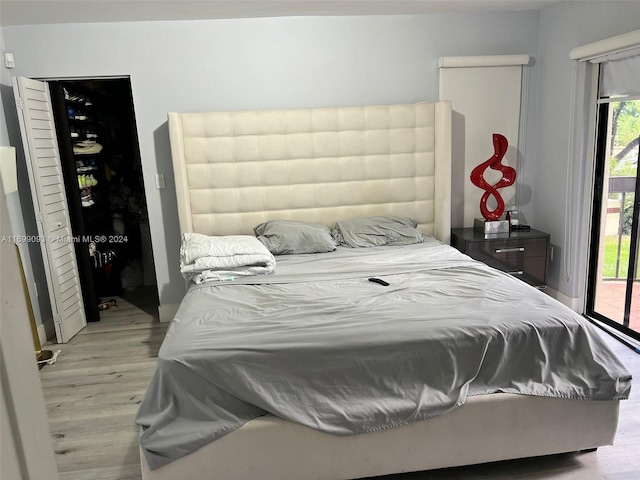 bedroom featuring access to outside and light hardwood / wood-style flooring