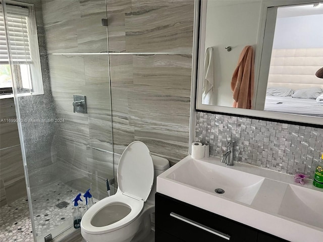 bathroom with backsplash, an enclosed shower, toilet, vanity, and tile walls