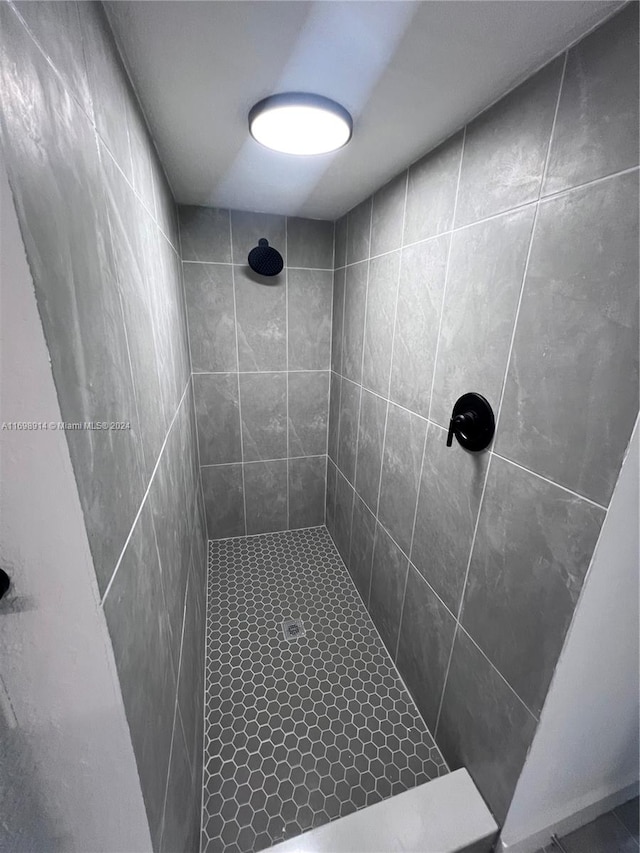 bathroom with tiled shower