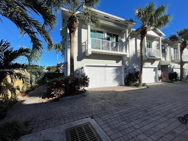 view of front of house featuring a balcony and a garage