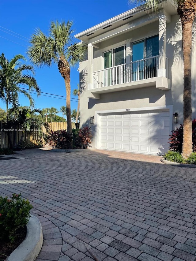 view of front of house featuring a garage and a balcony