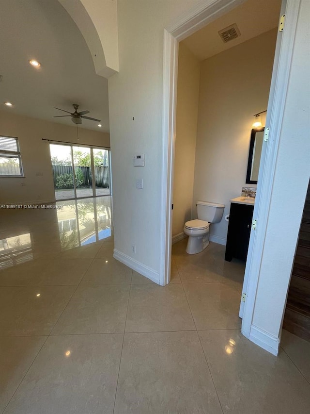 bathroom featuring tile patterned flooring, ceiling fan, toilet, and vanity