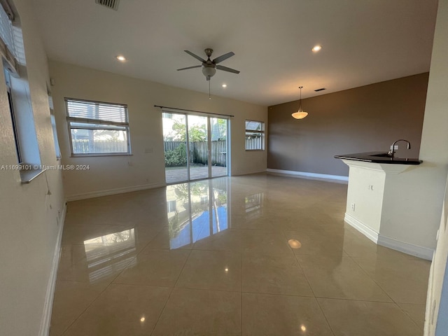 spare room with sink, ceiling fan, and light tile patterned flooring