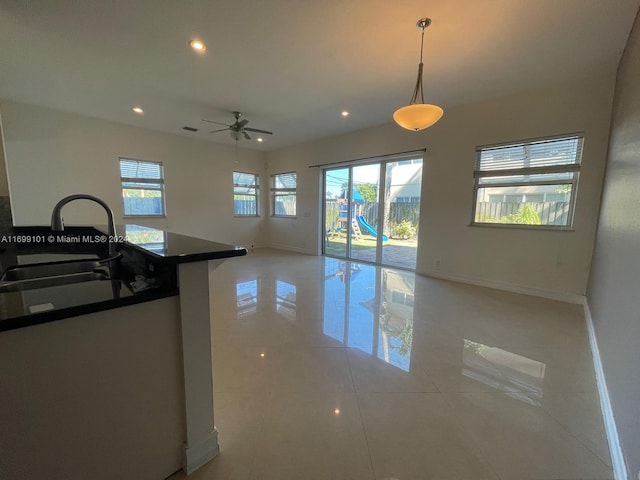 kitchen featuring light tile patterned floors, decorative light fixtures, a wealth of natural light, and ceiling fan