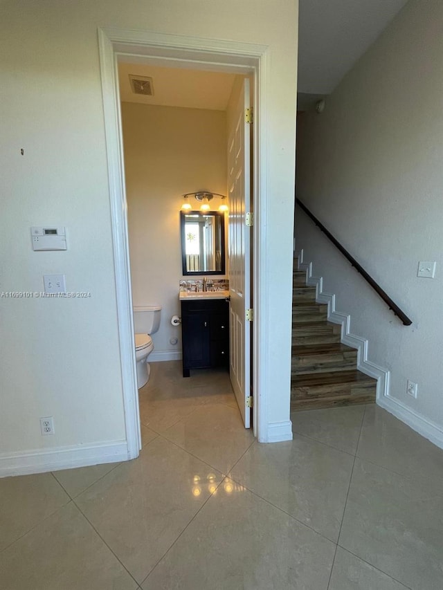 staircase with sink and tile patterned flooring