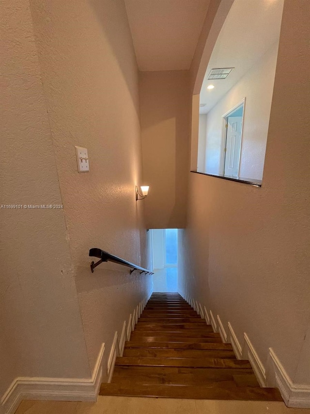 staircase with wood-type flooring