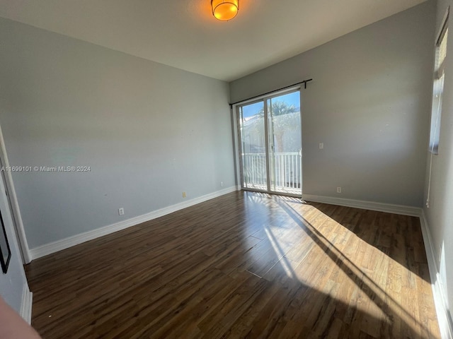 unfurnished room with dark hardwood / wood-style flooring