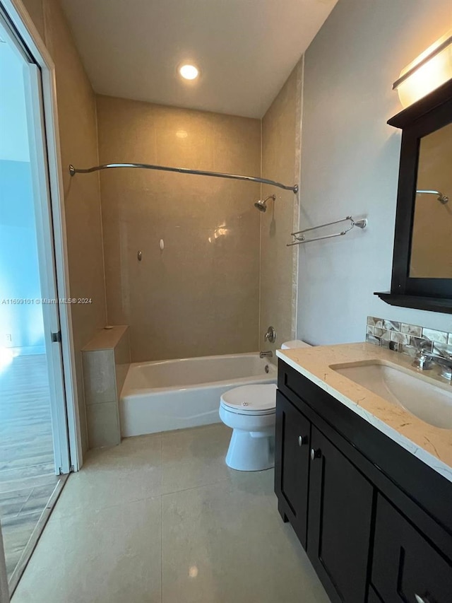 full bathroom featuring toilet, vanity, and tiled shower / bath combo