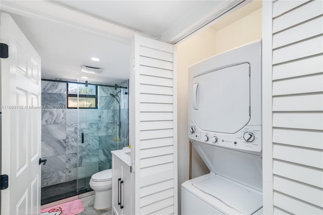 bathroom featuring walk in shower, tile patterned floors, toilet, vanity, and stacked washer and clothes dryer