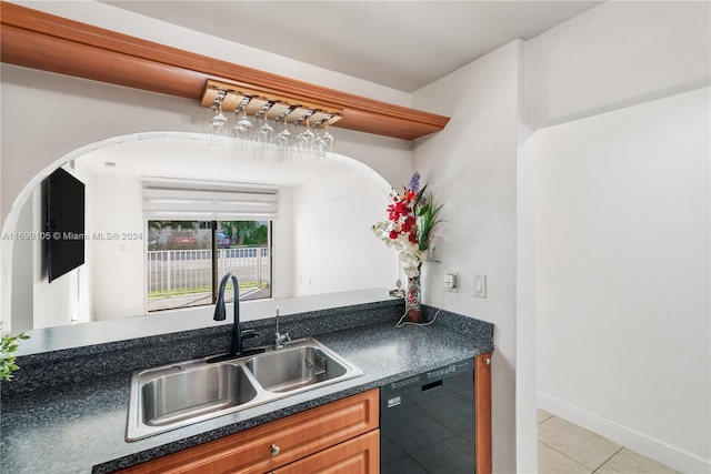 kitchen with dishwasher, light tile patterned flooring, and sink