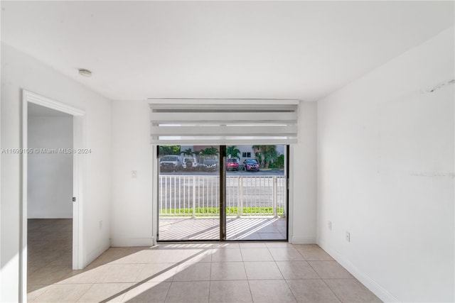 unfurnished room with light tile patterned floors