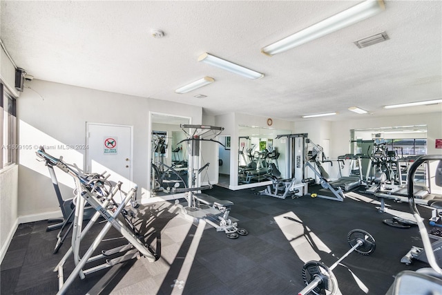 gym featuring a textured ceiling