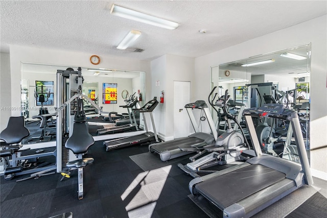 exercise room featuring a textured ceiling